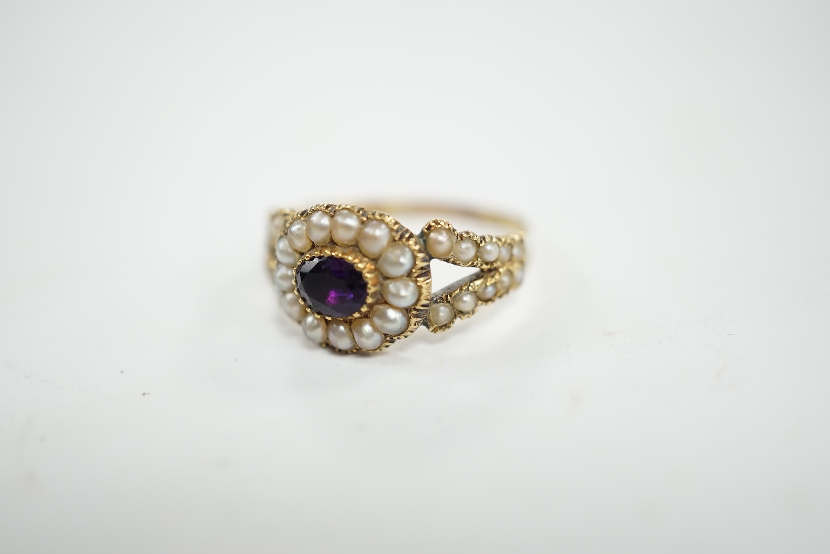 A Victorian yellow metal amethyst and seed pearl cluster set ring, size P/Q, gross weight 3 grams. Condition - poor